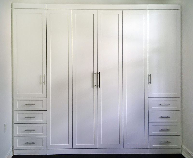 Queen sized Bi-fold murphy bed with a wardrobe storage and four drawers on each side, in white.